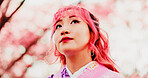 Cherry blossom, park and face of woman with kimono, thinking or outdoor sightseeing in nature with low angle. Culture, inspiration and Japanese girl in spring garden for traditional sakura festival
