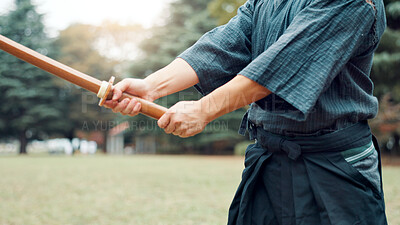 Buy stock photo Nature, bamboo sword and hands of Asian man in park for martial arts, Kendo practice and exercise. Culture, bokuto and person with shinai for skills, fitness and traditional sports in Japan outdoors