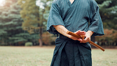 Buy stock photo Park, bamboo sword and hands of Asian man in nature for martial arts, Kendo practice and exercise. Culture, bokuto and person with shinai for skills, fitness and traditional sports in Japan outdoors