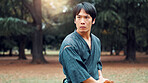 Wooden sword, Japanese man and outdoor in training, exercise and sports for martial arts or aikido. Male person, weapon and heritage for challenge, combat and practice as defense technique or bojutsu