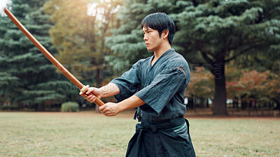 Buy stock photo Weapon, Japanese man and outdoor for martial arts as athlete in training, exercise or stance. Male person, culture and ready for challenge, combat and practice for self defence technique with bojutsu