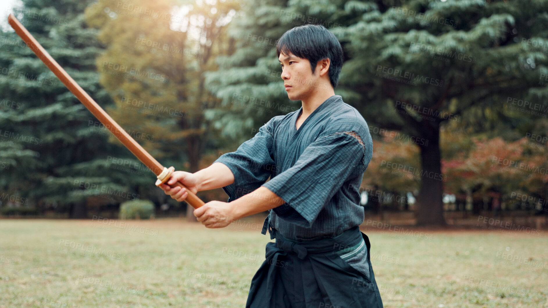 Buy stock photo Weapon, Japanese man and outdoor for martial arts as athlete in training, exercise or stance. Male person, culture and ready for challenge, combat and practice for self defence technique with bojutsu