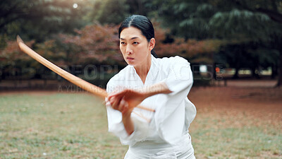 Buy stock photo Wooden sword, Japanese person and outdoor in training, exercise or sports as athlete for martial arts. Woman, culture and weapon for challenge, combat and practice for defense technique with bojutsu