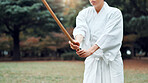 Culture, Japanese person and outdoor for martial arts in training, exercise or sports as athlete. Woman, weapon and heritage for challenge, combat and practice for self defense technique with bojutsu