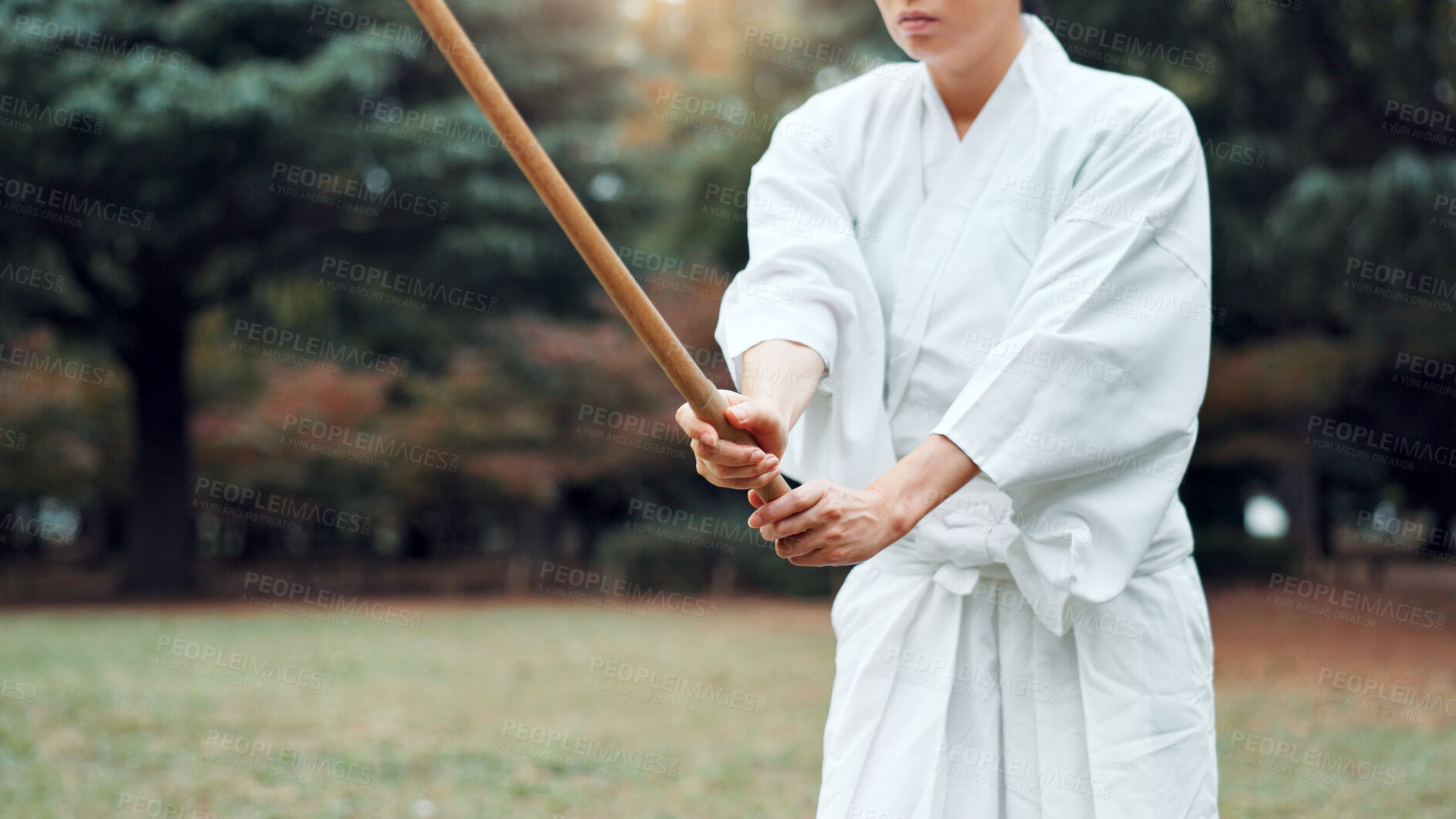 Buy stock photo Bokken, Japanese person and outdoor for martial arts in training, exercise or sports as athlete. Woman, weapon and heritage for challenge, combat and practice for self defense technique with bojutsu
