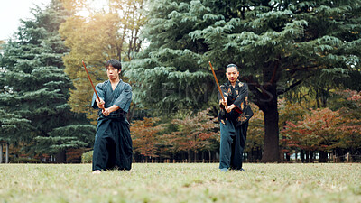 Buy stock photo Sword, martial arts and people in nature training together for aikido, fight coaching or outdoor samurai challenge. Warrior, Japanese man and woman in park for traditional bokken battle with wood