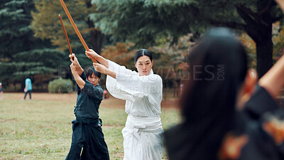 Buy stock photo Bokken, Japanese culture and outdoor for martial arts in training, exercise or sports as athlete. People, weapon and heritage for challenge, combat and practice as self defense technique with bojutsu