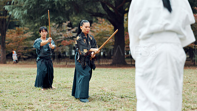 Buy stock photo Martial arts, exercise and class instructor with wood sword for fight, battle and samurai training. Park, ninja and mentor with bamboo weapon, kendo and warrior in autumn in Japan with fighter group