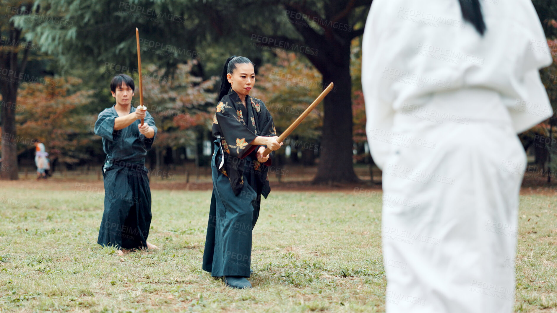 Buy stock photo Martial arts, exercise and class instructor with wood sword for fight, battle and samurai training. Park, ninja and mentor with bamboo weapon, kendo and warrior in autumn in Japan with fighter group