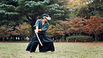 Virtual reality, Japan and Asian man with sword for martial arts, Kendo practice and exercise. Culture, heritage and person with shinai, VR tech and goggles for skills, fight and training in park