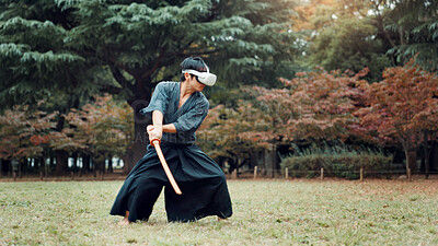 Buy stock photo Virtual reality, Japan and Asian man with sword for martial arts, Kendo practice and exercise. Culture, heritage and person with shinai, VR tech and goggles for skills, fight and training in park