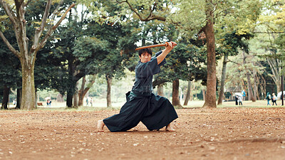 Buy stock photo Kenjutsu, training and bamboo sword with Japanese man in park for martial arts, culture and samurai warrior. Self defense, kendo master and safety with person in Japan nature for shinai combat