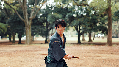 Buy stock photo Bokken, Japanese man and outdoor for martial arts in training, exercise or sports as athlete. Culture, weapon and male person for heritage, combat and practice for self defense technique with bojutsu
