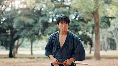 Buy stock photo Man, fitness or outdoor with sword for martial arts, demonstration or training tradition in Kyoto. Japanese samurai, weapon or indigenous culture in park for kendo, practice or self defense technique