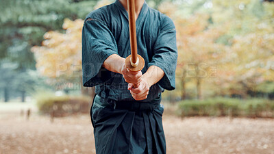 Buy stock photo Bokken, Japanese person and outdoor as practice, exercise and sport in culture or martial arts. Performance, weapon and heritage for challenge, combat or training as self defense technique in bojutsu