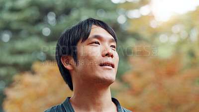 Buy stock photo Face, smile and thinking with man in park adventure, conservation or planning of journey or trip. Future, idea and vision with happy Japanese person outdoor in nature for hiking, travel or wellness