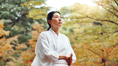 Buy stock photo Thinking, fighter and woman with kimono, martial arts and weapon for training, fitness and aikido. Woods, contemplating and person with skills for bamboo sword, ideas and technique for kendo in Japan