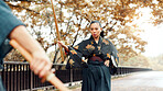 City, Kendo sword and Asian woman with trainer for martial arts, practice and exercise. Culture, heritage and person with shinai, bokuto and weapon for skill, fight or traditional training in Japan