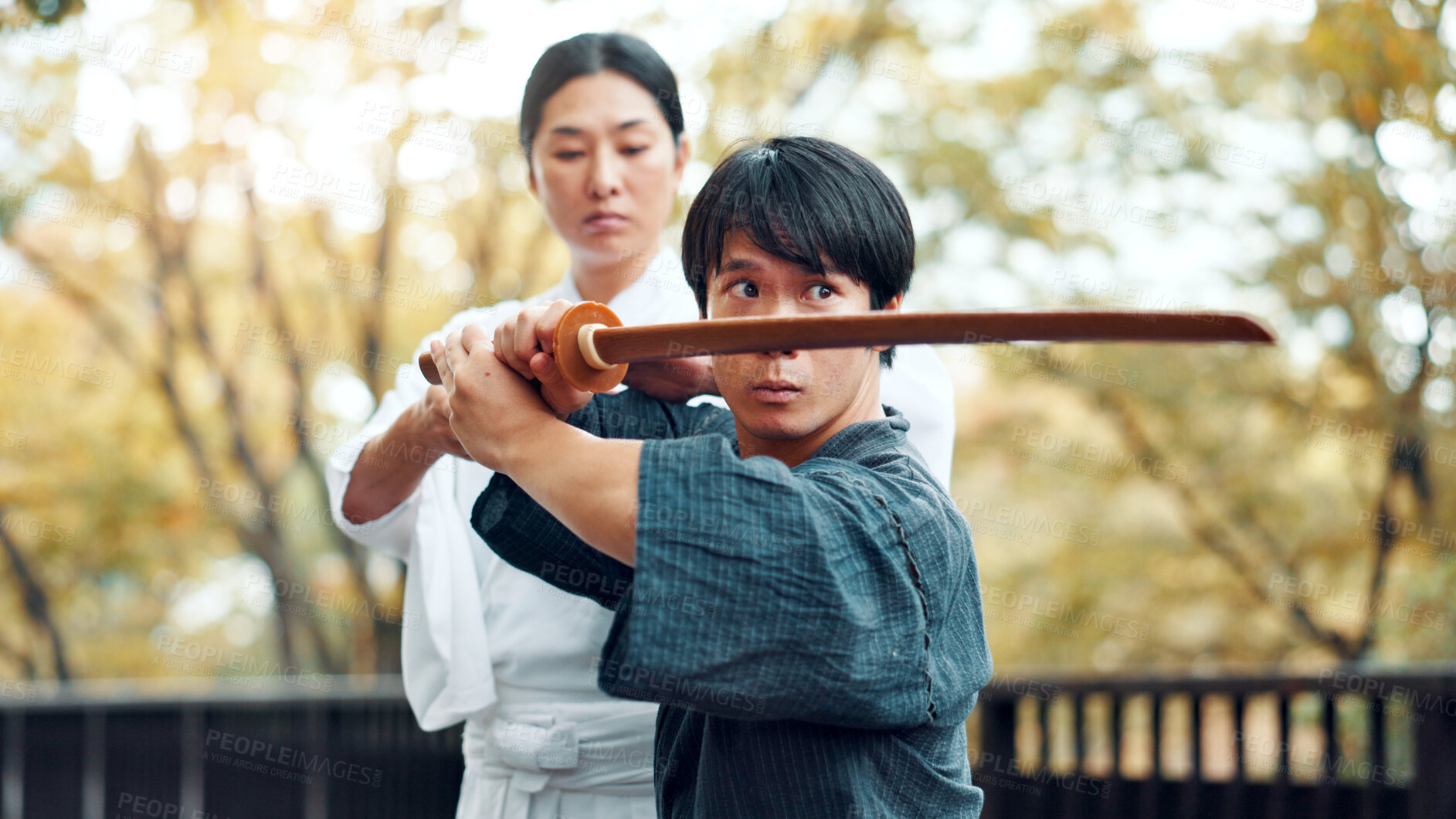 Buy stock photo City, bamboo sword and Asian man with instructor for martial arts, Kendo practice and exercise. Culture, heritage and person with shinai, bokuto and weapon for skill, fight and training in Japan