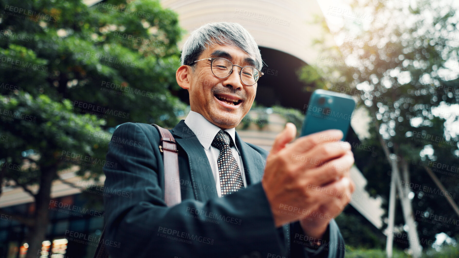 Buy stock photo Outdoor, businessman and smile on smartphone on website for stock exchange rates in Japan. Mature person, city and happy as employee in finance on mobile app for market share or investment returns