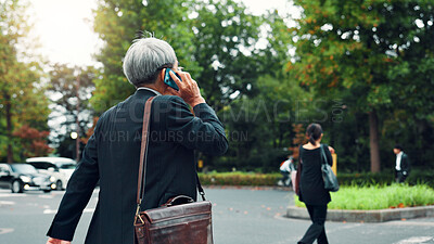 Buy stock photo Phone call, back and business person with smartphone, walking and commuting to work, talking and travel. Conversation, outdoor and employee with mobile, networking and discussion for sales and Japan