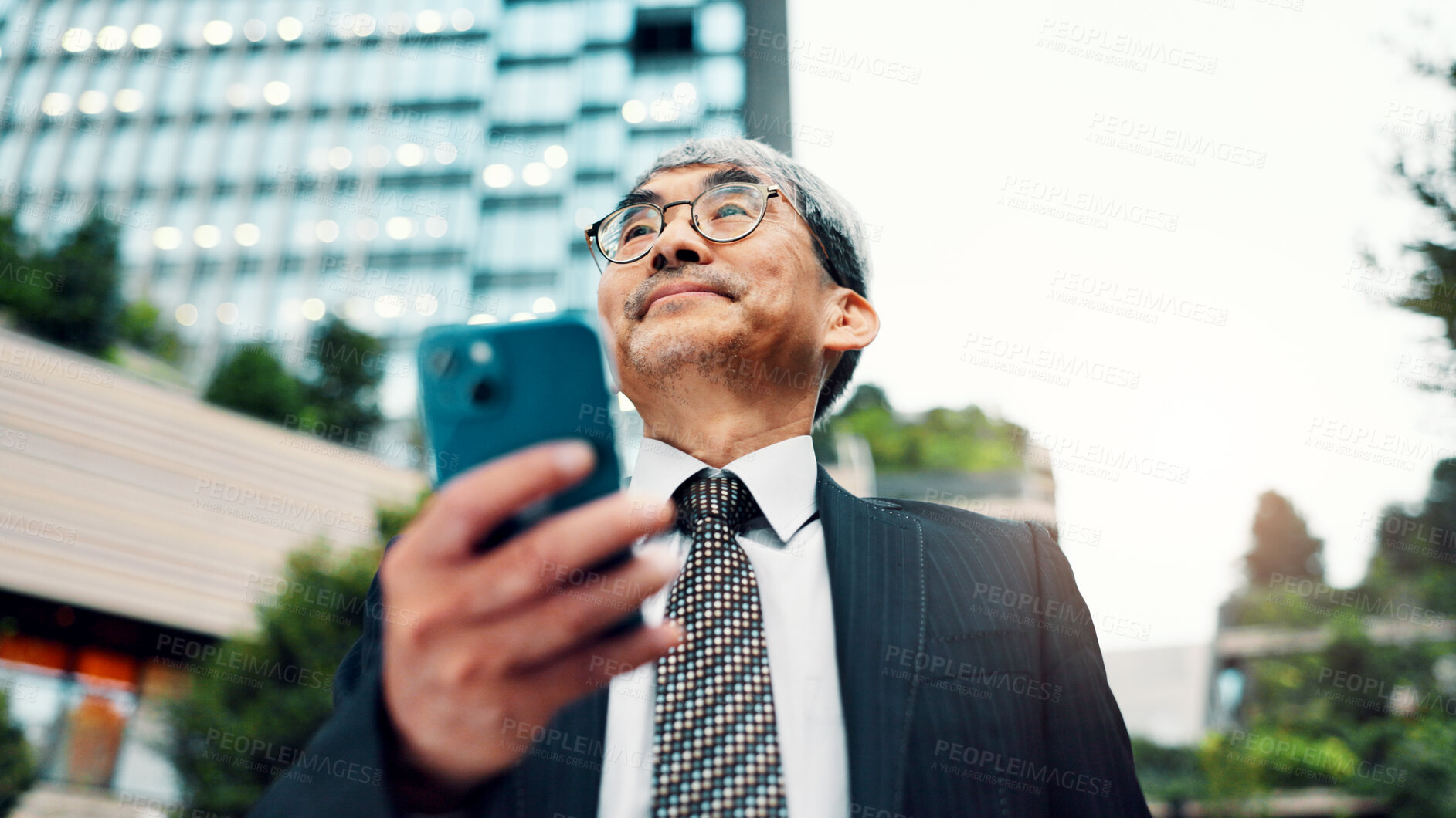 Buy stock photo Mature, business and man with phone in city of communication, planning travel and schedule update. Thinking, person and low angle of negotiation feedback, location directions and information in Japan