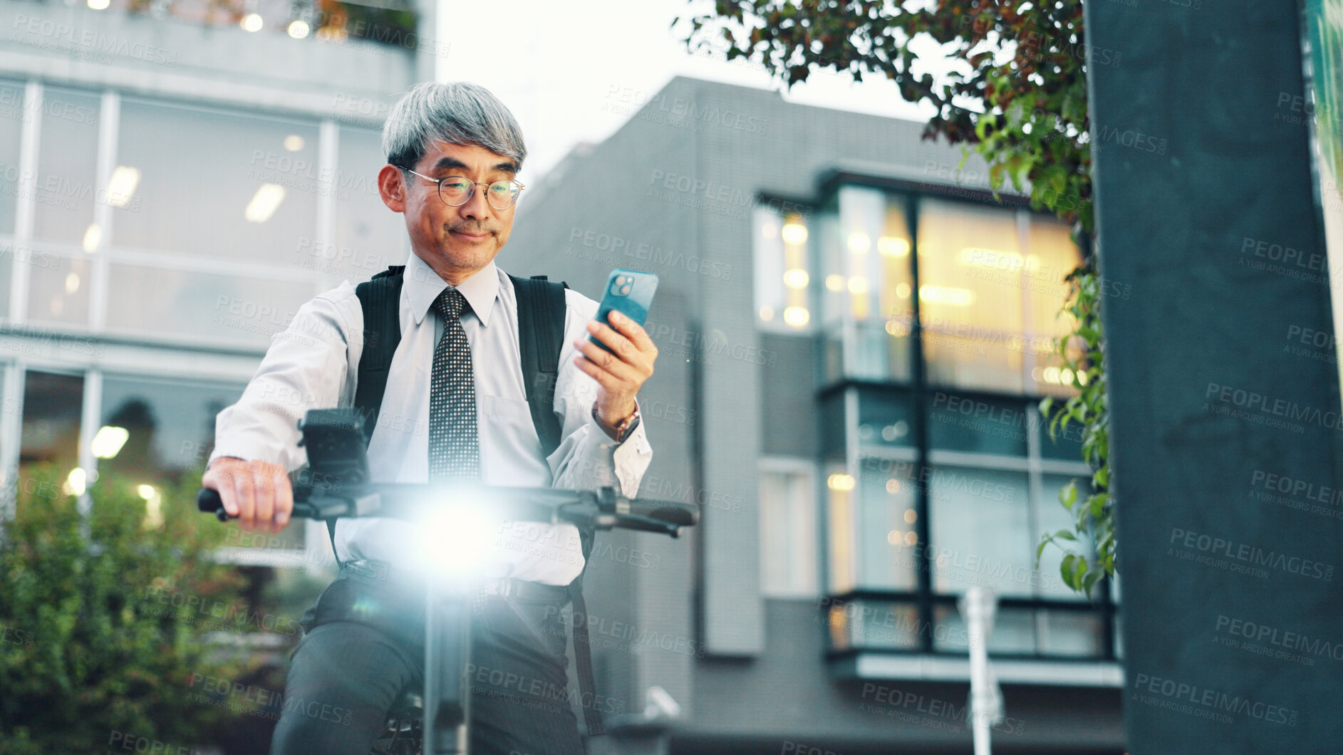 Buy stock photo Businessman, mobile or electrical bike in city for travel, clean energy or sustainable transport. Commute ride, mature or eco friendly bicycle with phone or technology for location or map in Japan