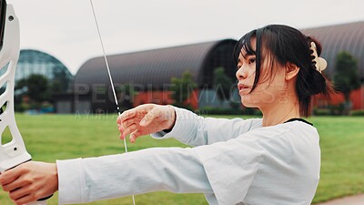 Buy stock photo Woman, archery and serious at field with sport for shooting practice and training as athlete in Japan. Tournament, female person and setup recurve bow or equipment for challenge, game or competition 