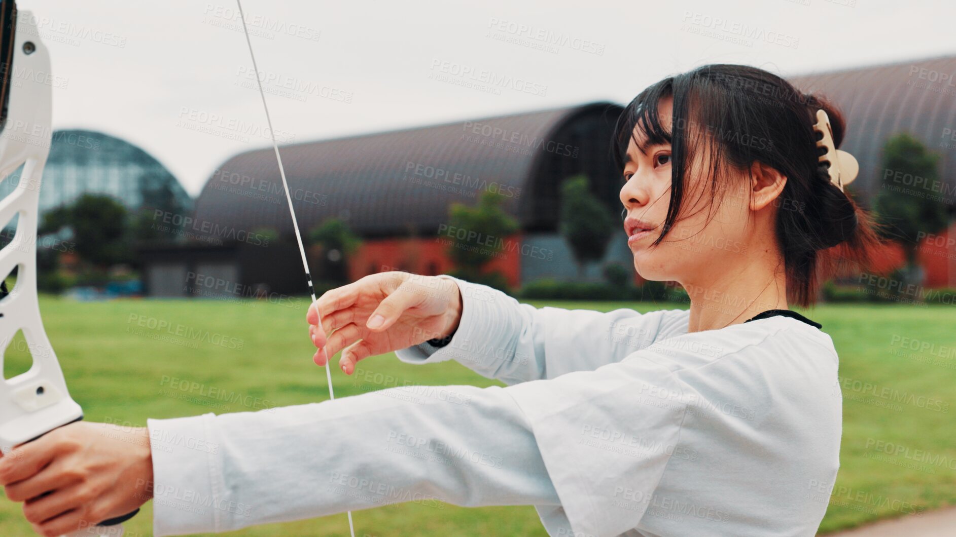 Buy stock photo Woman, archery and serious at field with sport for shooting practice and training as athlete in Japan. Tournament, female person and setup recurve bow or equipment for challenge, game or competition 