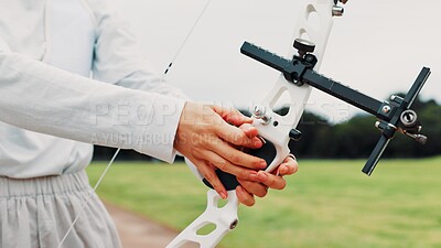 Buy stock photo Person, archery and hands at field for sport at shooting practice and training as athlete in Japan. Closeup, target and setup recurve bow or equipment for challenge, tournament and competition 