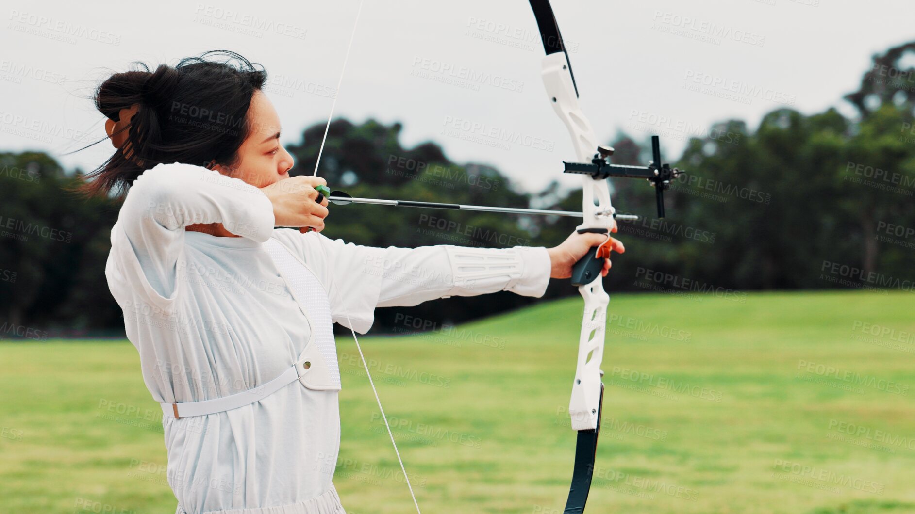 Buy stock photo Field, archer and woman with bow, aim and preparing for competition, equipment and outdoor for game. Contest, archery and practice from tournament, skills and challenge for person, training and Japan