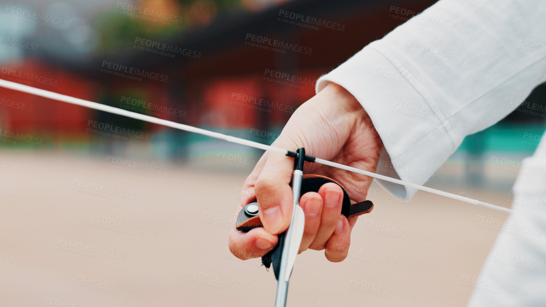 Buy stock photo Archery, person and hands with arrow, bow or string for aim, skill or talent in preparation for precision or hunting in city. Japan, closeup or professional archer with weapon for sport or combat