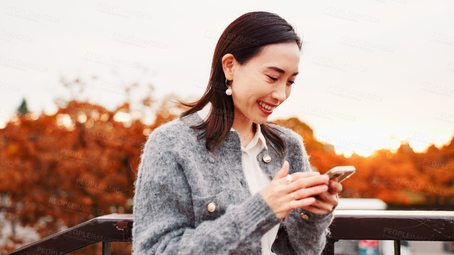 Buy stock photo Smile, travel and woman with phone at park on holiday, text or blog on notification app in Japan. Scroll, mobile and Asian person outdoor for chat, reading post and social media on vacation at sunset