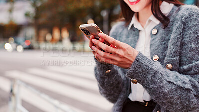 Buy stock photo Hands, phone and happy woman in city for travel, text or message on app on holiday in Japan. Smile, mobile and person on street for chat, communication and post on social media profile on internet