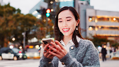 Buy stock photo Smile, mobile and Asian woman in city for reading text, message or travel blog on holiday. Happy, phone and Japanese person on street for chat, communication and post on social media profile at night