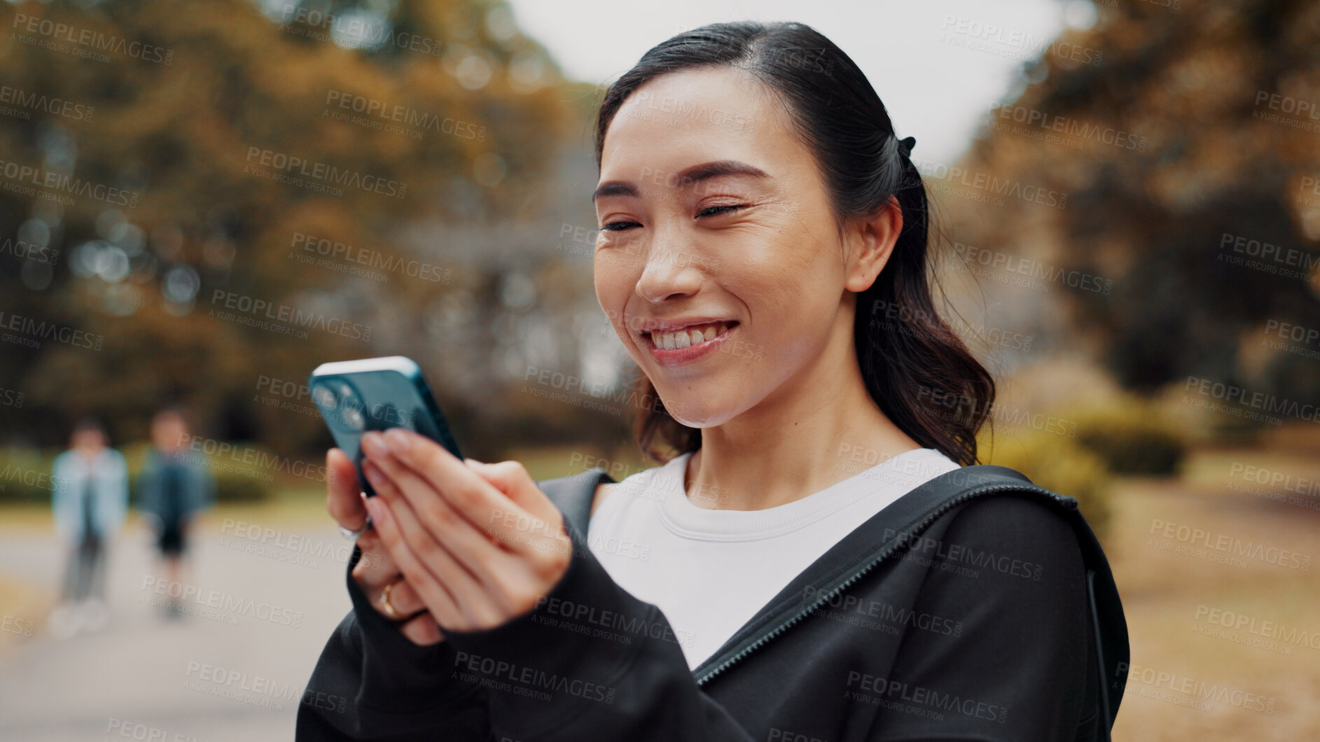 Buy stock photo Happy, woman and typing with phone for fitness at park, communication and travel of exercise application. Smile, athlete and mobile of sport membership, training schedule and workout routine in Japan