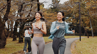 Buy stock photo Women, running and bonding for fitness, cardio and training for body goals, wellness or active in morning. Outdoor, smile and workout for Japanese friends, health and together for exercise routine