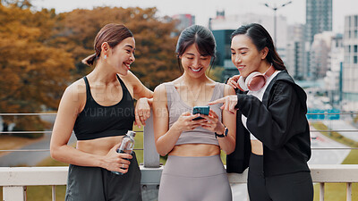 Buy stock photo Japan, friends and women with smartphone, fitness and typing with funny meme. Group, outdoor and runners with cellphone, mobile user and technology for online reading, digital app and workout goals