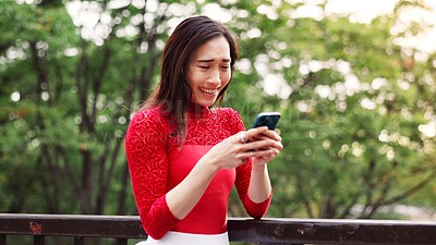 Buy stock photo Woman, phone and texting on bridge in park with laughing, excited and reading post on mobile app in summer. Person, smartphone and happy with contact, chat and notification with funny meme in Japan