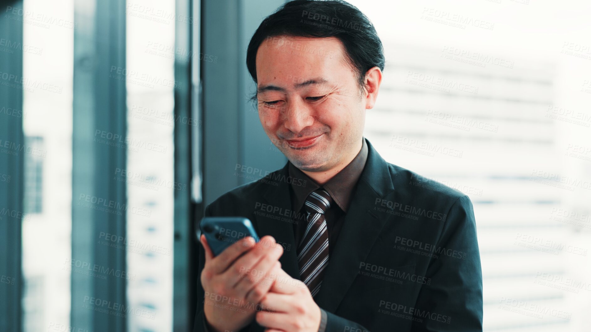Buy stock photo Businessman, phone or smile at window for research, planning or feedback in Japanese company. Finance investor, tech or reading in office for audit report, stock market news or investment opportunity