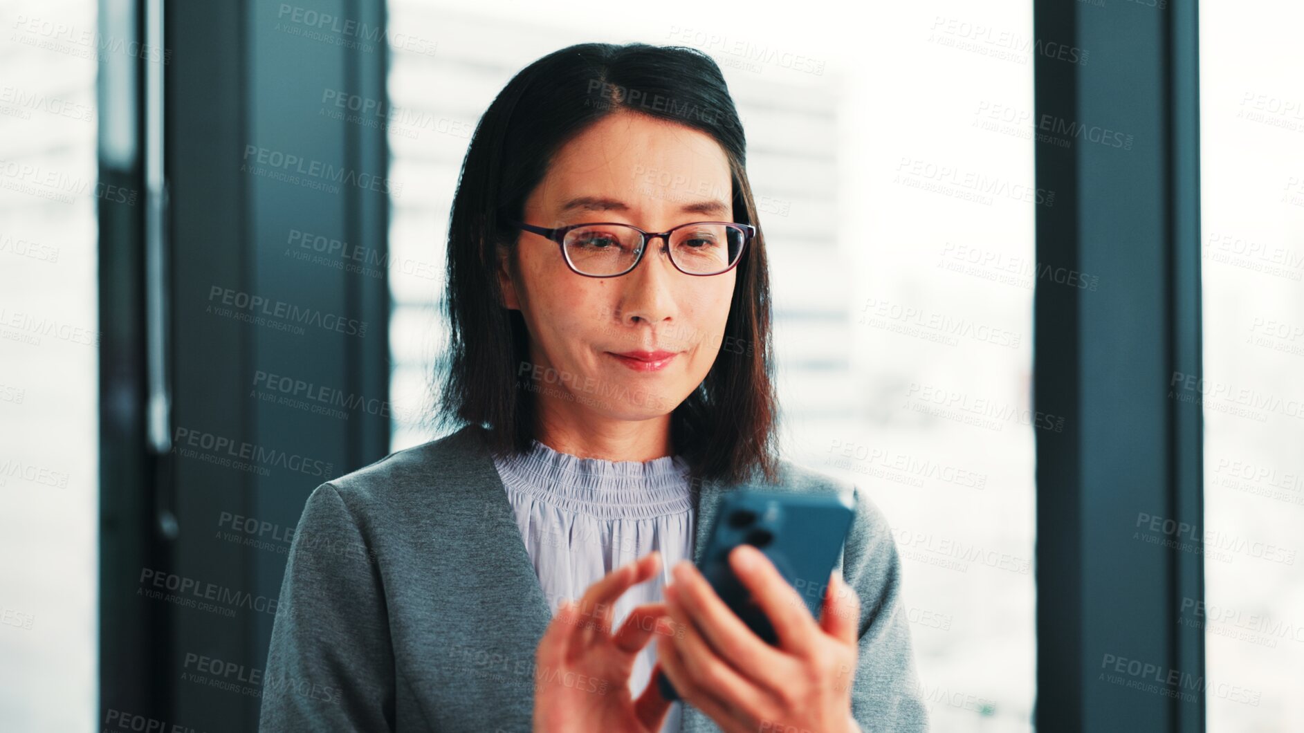 Buy stock photo Woman, phone or smile at window for business, research economy or good news in Japanese company. Finance investor, mobile or typing in office for report, stock market update or investment opportunity