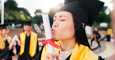 Buy stock photo Graduation, student and kiss diploma with celebration for education success, achievement and ceremony. Japanese university, girl and certificate on campus for learning goals, academic event and pride