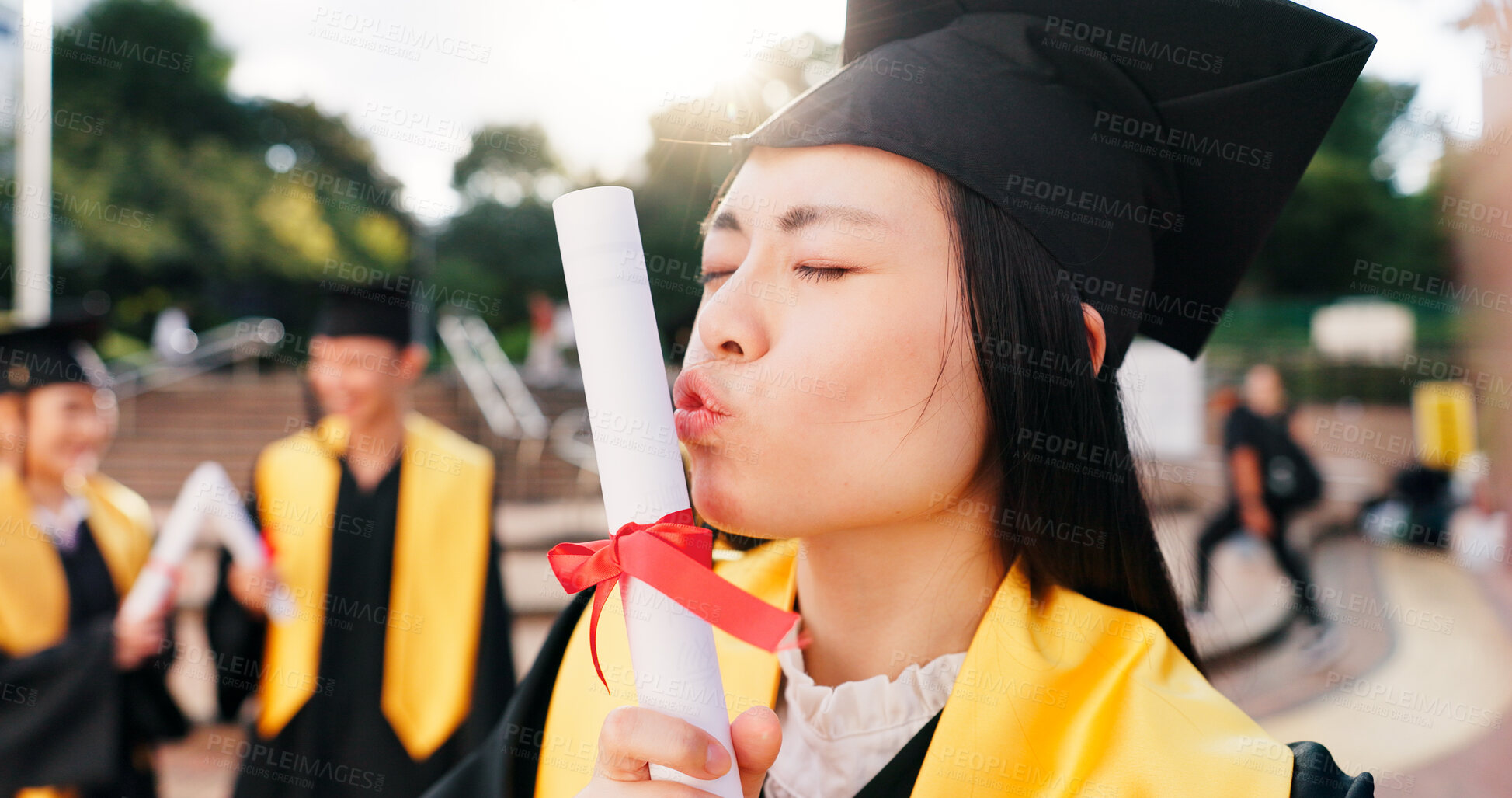 Buy stock photo Graduation, student and kiss diploma with celebration for education success, achievement and ceremony. Japanese university, girl and certificate on campus for learning goals, academic event and pride