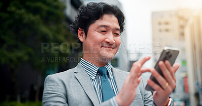 Buy stock photo Business, man and typing with phone in city for mobile chat, online research and happy for notification. Japanese person, smile and smartphone in urban town for checking schedule on morning commute