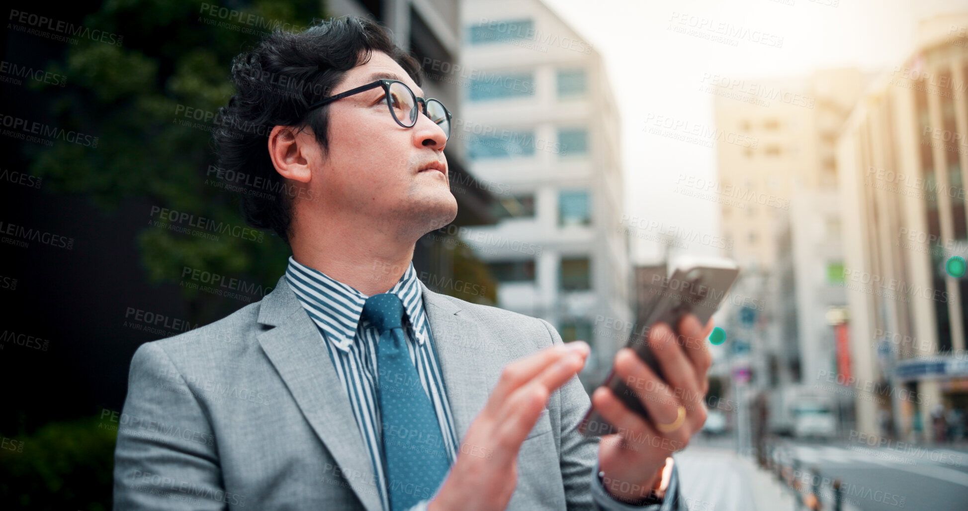 Buy stock photo Japanese man, city street and smartphone for location search, direction and navigation on application. Male person, mobile technology on sidewalk for commute, travel and walk as real estate developer