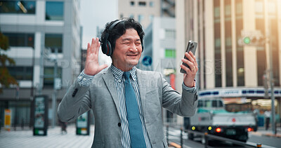 Buy stock photo Asian man, headphones or wave with phone for video call, communication or commute in city. Japan, businessman or talking with mobile smartphone for virtual meeting, discussion or conversation in town