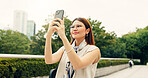 Woman, travel and selfie with confident in city, memory and photography for post with mobile app in nature. Person, smile and profile picture with inspiration, reflection and outdoor at park in Japan