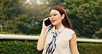 Woman, smile and phone call in park for business, booking accommodation and travel update in Tokyo. Japanese girl, glasses and outdoor with technology for contact, communication or career opportunity