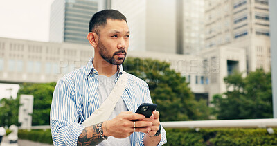 Buy stock photo Japan, thinking and man in city, cellphone and wonder with connection, travel and internet. Asian person, outdoor and guy in street, decision or smartphone with social media and message to contact