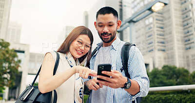 Buy stock photo Couple, smartphone and travel with direction in city, click and mobile app for location, landmark and smile in street. People, man and woman with phone, talking and search on urban sidewalk in Japan